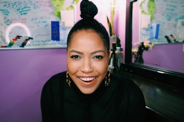 smiling-happy-woman-black-shirt-ponytail