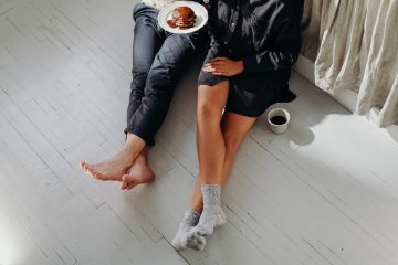 aeriel view of couple from waist down eating breakfast