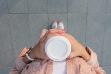 aerial view of woman holding coffee cup